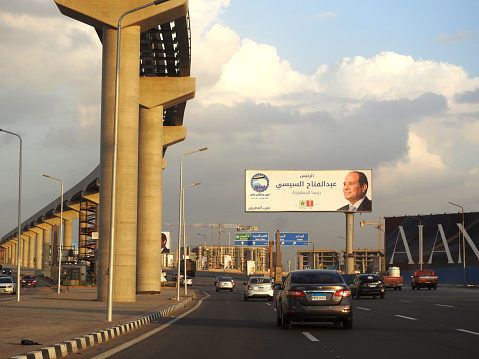 Cairo, Egypt, November 14 2023: Egyptian presidential election campaign banners, Egypt's president election 2024 advertisement near Cairo monorail site with columns and tracks under construction, selective focus