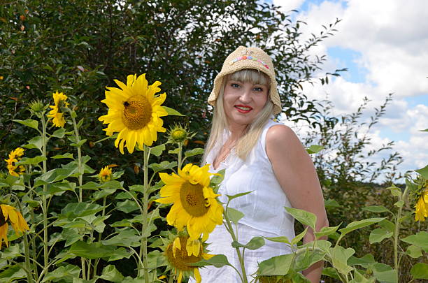 istock Young girl and sunflowers 181565230
