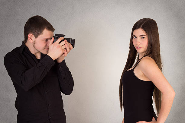 istock Photographer taking pictures of model in studio 181567357