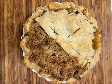 A unique combination apple pie, one half crumb top, one half regular pie crust