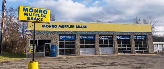 Warren, Pennsylvania, USA November 23, 2023 The Monro Muffler Brake business building, an auto repair shop on a sunny fall day