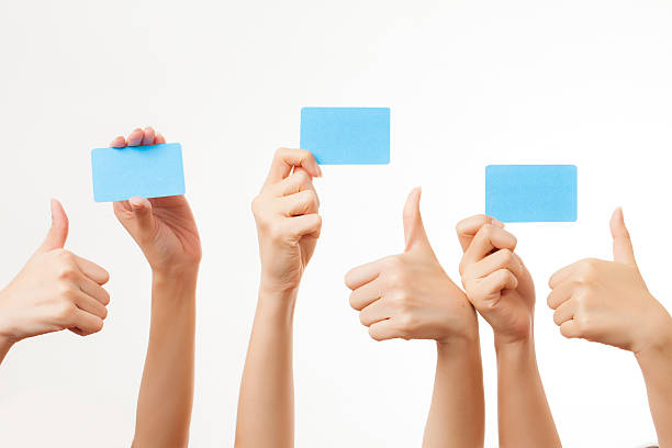 istock Several hands hold blank business cards on white background 181575324