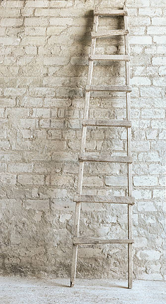 istock ladder near the brick wall background 181575576