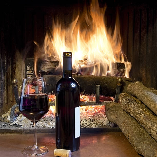 istock glass wine in front of a fireplace 181577905