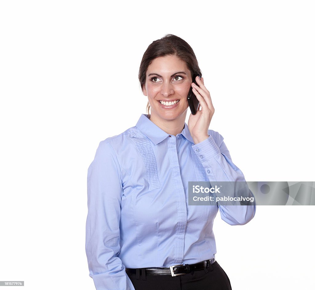 Beautiful woman talking on her cellphone A portrait of a beautiful woman on blue blouse talking on her cellphone and smiling on isolated background - copyspace Adult Stock Photo
