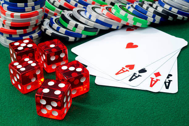 istock Red dice, four aces and chips on a green felt. 181578746