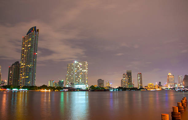 istock city downtown at night with building reflection in the river. 181581055