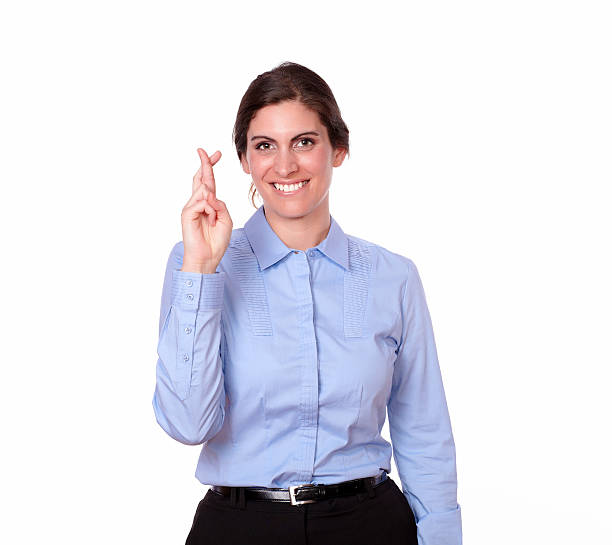 istock Beautiful woman smiling with luck sign 181581189
