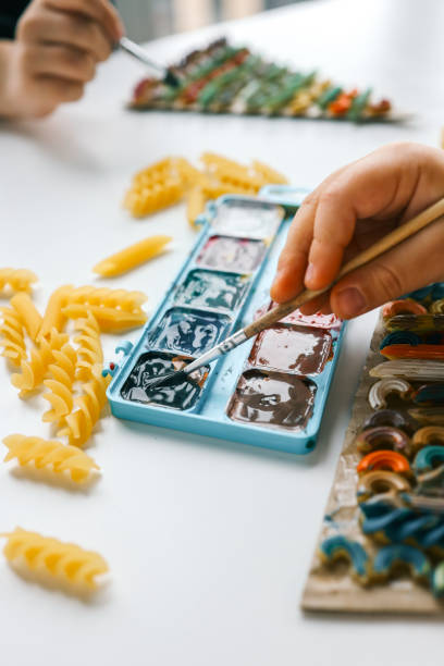 istock Sensory creative activity for children, child coloring pasta 1815816106