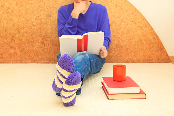 istock Home study-Man with cup of coffee reading book 181583561