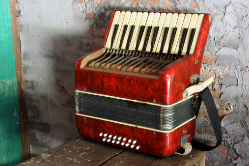 Small accordion on the table is a self contained music maker