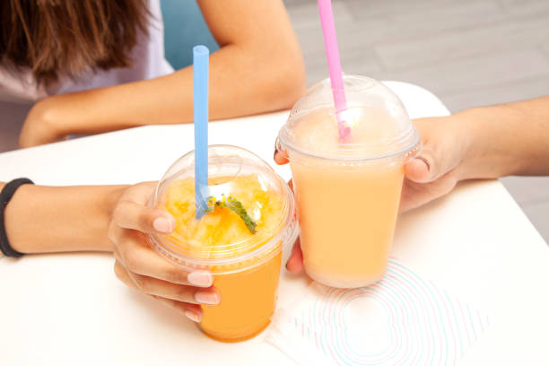 istock Friends holding drinking together fruity slush drinks. 1815859917