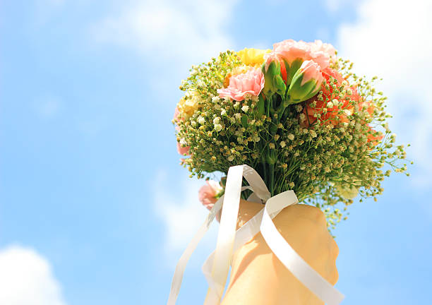 istock Bouquet of flower in hand and blue sky 181586404
