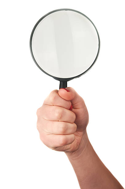 istock woman holds magnifying glass 181586979