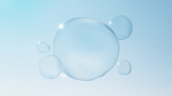 An underwater photograph of bubbles on a clear blue background.  The bubbles are randomly dispersed.  The bubbles vary in size with most being very small and a few being larger.  The background is a translucent blue.  The light comes from the bottom of the photo, making the bottom of the background very light blue, while the top is a darker shade.  The water is free of any visible impurities.  The bubbles seem to be largely concentrated in the upper right portion of the center of the photo, as well as the upper middle.