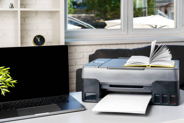 istock New modern printer and laptop in the office on table 1815931582