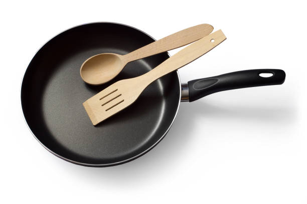 istock A modern frying pan with a wooden spoon and spatula. 1815935285