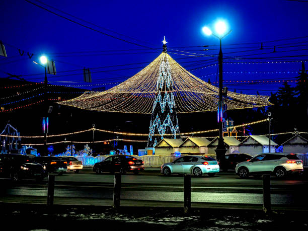 istock Christmas tree with a luminous illuminating at night on the square 1815939884