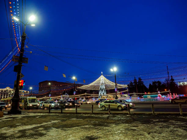 istock Christmas tree with a luminous illuminating at night on the square 1815939886