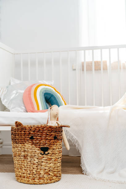 istock Kid's room interior with comfortable bed and rainbow pillow 1815940406