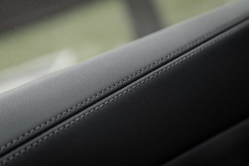 Part of leather car details. Сlose-up black  leather car seat.