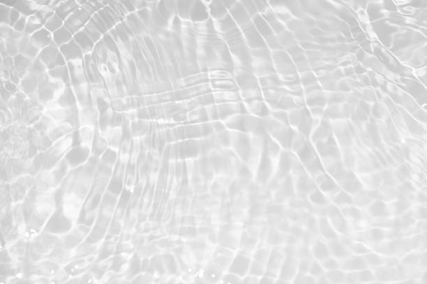 istock White water with ripples on the surface. Defocus blurred transparent white colored clear calm water surface texture with splashes and bubbles. Water waves with shining pattern texture background. 1815943986