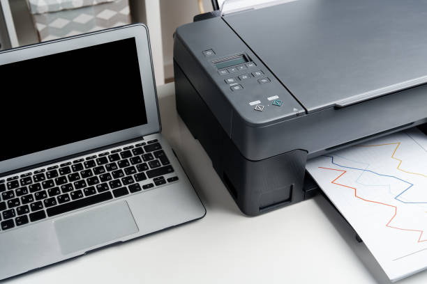 istock New modern printer and laptop in the office on table 1815949301