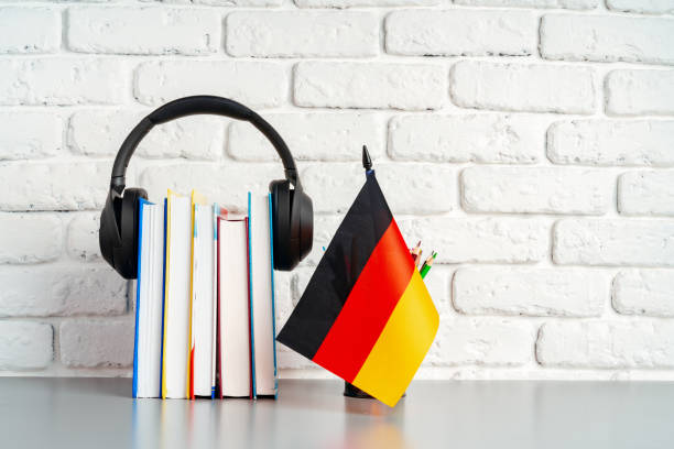 istock Stack of books and flag of Germany on desk. German language learning concept 1815959311