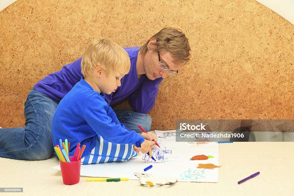 father and son drawing together Activity Stock Photo