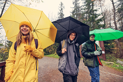 Three teenagers hiking on a rainy autumn day.
Canon R5