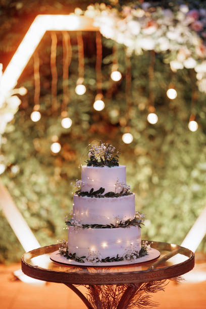 istock Wedding cake with flowers and greenery on arch 1815991477