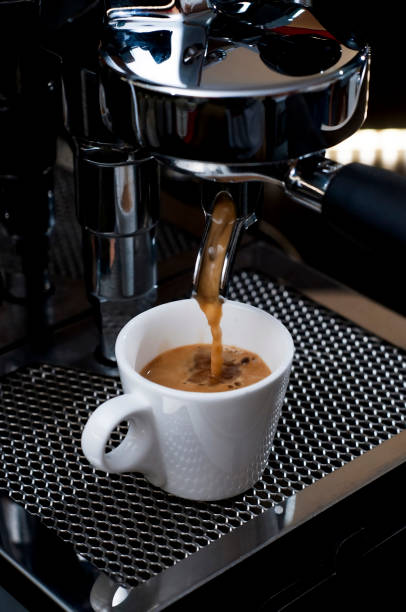 istock espresso coffee maker is pouring hot coffee into cups 1815994169