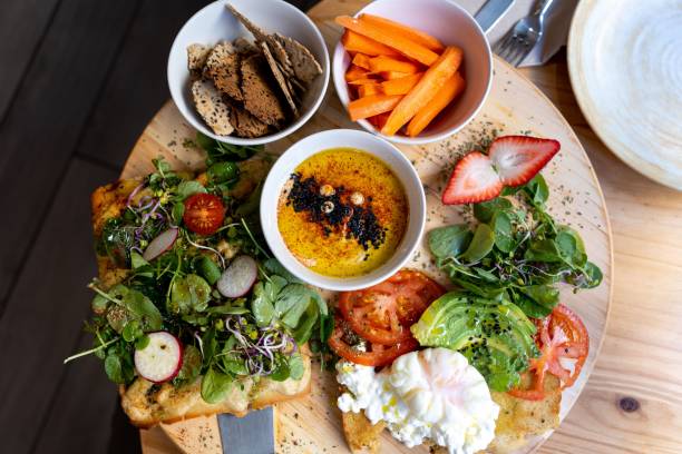 istock Wooden table presented with several plates of food arranged on it 1816026709