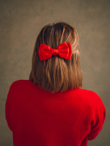 Woman in red sweater and red hair bow hairstyle
Photos taken in studio