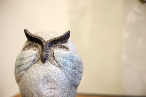 close up of a ceramic owl in a museum,shallow depth of field