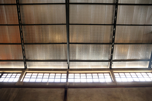Roof with sun light in the old factory building of thailand