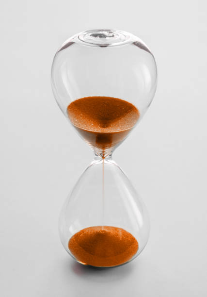 istock Hourglass containing orange sand isolated on white background 1816033175