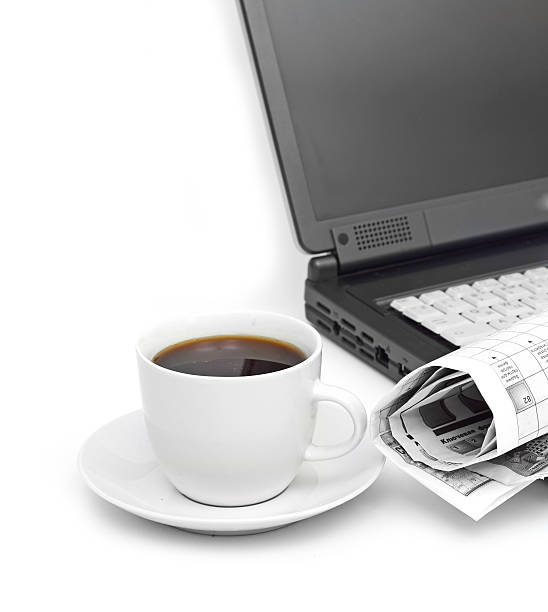 istock cup of coffee on a laptop 181604272