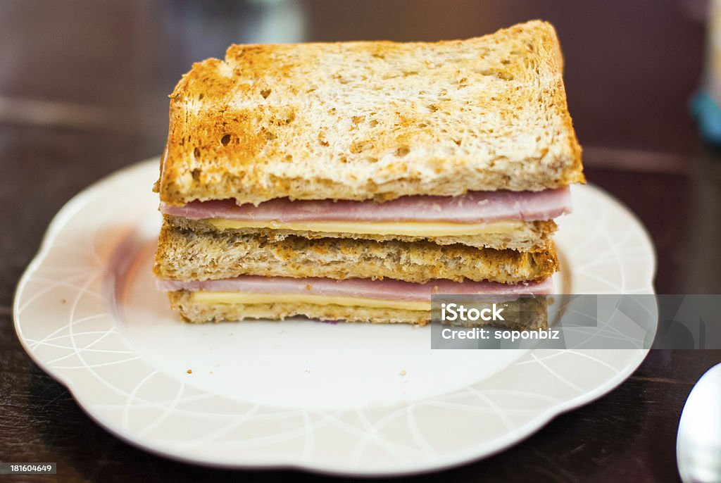 Toasted sandwich with ham and cheese Toasted sandwich with ham and cheese in white dish Bread Stock Photo