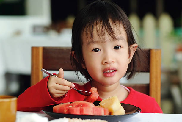 istock asian girl eating 181605764