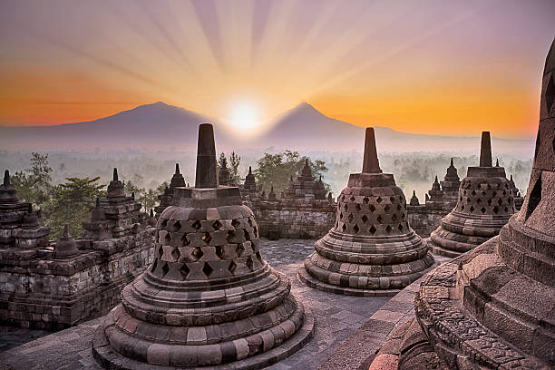 istock Borobudur temple and mountain at sunrise 181606474