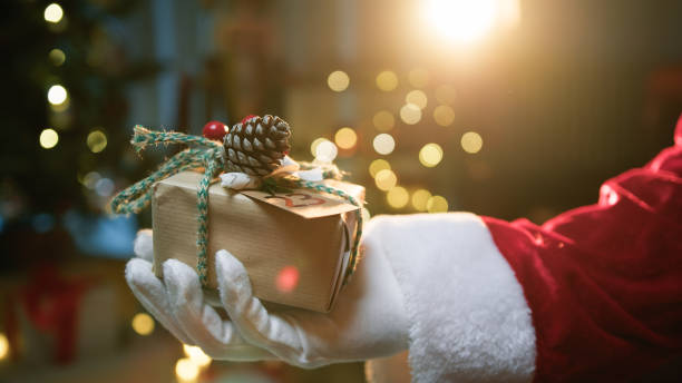 istock Santa Claus Hand Donate a Christmas Gift 1816066561
