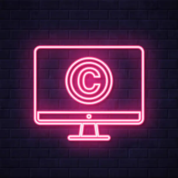 Vector illustration of Desktop computer with copyright symbol. Glowing neon icon on brick wall background