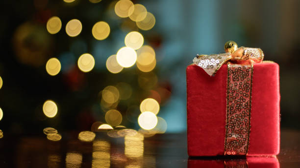 istock Red Christmas Red Presents Against Tree 1816073074