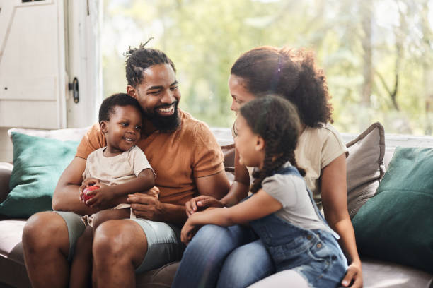 istock Happy black family talking on sofa at home. 1816074681
