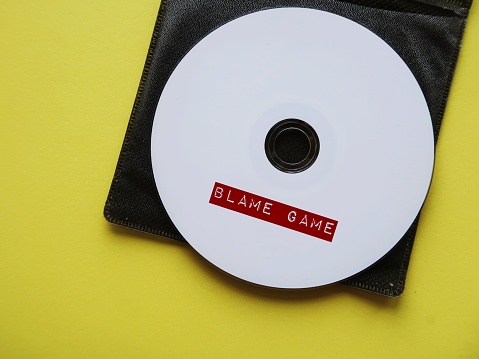 CD on yellow background with title tag BLAME GAME, situation when people attempt to blame each other when bad things has happened