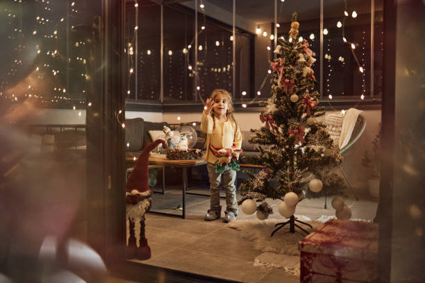 istock Happy girl decorating Christmas Tree 1816093976