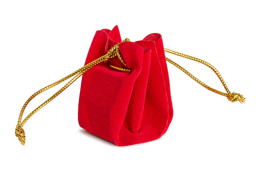 Red velvet tied small gift bag isolated over white