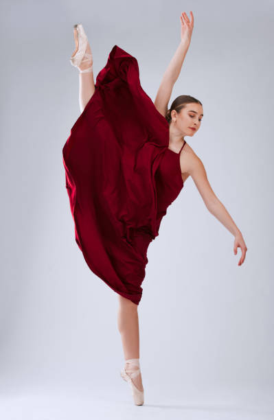 istock Ballet, talent and woman in studio for training, creative routine and ready for performance, show or artist with movement on grey studio background. Dancer, ballerina or female performer with balance 1816097701