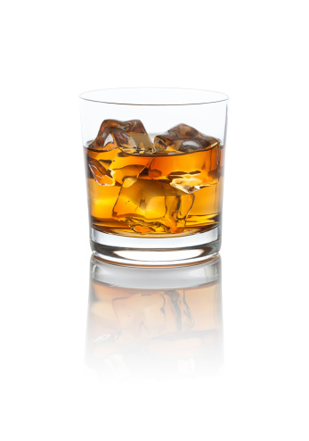 Smokey Scotch Whiskey on the rocks with a nice reflection. Isolated on white with clipping path.